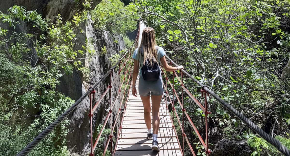 Hiking in Granada: crossing a hanging bridge in a natural setting